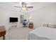 Bright bedroom with a ceiling fan, a large window, and carpeted floors at 2019 Aldbury Ln, Woodstock, GA 30189