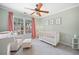 Charming Bedroom with ample natural light, featuring a crib and comfortable seating at 2019 Aldbury Ln, Woodstock, GA 30189