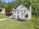 A well-manicured two-story home boasts beautiful landscaping and classic architectural details at 2019 Aldbury Ln, Woodstock, GA 30189