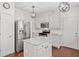 Beautifully renovated kitchen featuring granite countertops, stainless steel appliances, and modern lighting at 2019 Aldbury Ln, Woodstock, GA 30189