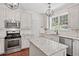 Updated kitchen with granite countertops, stainless steel appliances, and ample cabinet space at 2019 Aldbury Ln, Woodstock, GA 30189