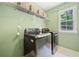 Well-lit laundry room with washer, dryer, shelving, and a window with natural light at 2019 Aldbury Ln, Woodstock, GA 30189