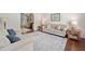 Cozy living room with hardwood floors, neutral decor, and abundant natural light at 2019 Aldbury Ln, Woodstock, GA 30189