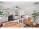 Bright living room featuring a fireplace with custom built-ins, hardwood floors, and stylish furnishings at 2019 Aldbury Ln, Woodstock, GA 30189