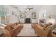 Cozy living room with a fireplace, built-in shelves, and comfortable leather chairs with ottoman at 2019 Aldbury Ln, Woodstock, GA 30189