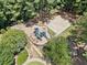An aerial view of a playground and play area with a basketball court surrounded by mature trees at 2019 Aldbury Ln, Woodstock, GA 30189
