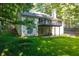 A charming two-story home showcasing a private backyard and deck, surrounded by lush greenery and trees at 2030 Buford Dam Rd, Buford, GA 30518