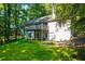Backyard featuring a wooden deck and walkout basement surrounded by mature trees at 2030 Buford Dam Rd, Buford, GA 30518