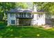 Exterior of home featuring a walkout basement and wooden deck overlooking the wooded lot at 2030 Buford Dam Rd, Buford, GA 30518