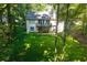 A charming two-story home showcasing a private backyard and deck, surrounded by lush greenery and trees at 2030 Buford Dam Rd, Buford, GA 30518