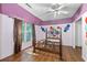 Bedroom features wood flooring, a ceiling fan, an iron bed frame, and a large window at 2030 Buford Dam Rd, Buford, GA 30518