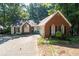 Charming single-story home with a brick facade and a well-manicured front yard at 2030 Buford Dam Rd, Buford, GA 30518