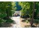 Ranch home with long drive surrounded by mature trees and well-manicured yard at 2030 Buford Dam Rd, Buford, GA 30518