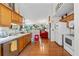 Open-concept kitchen with wood cabinets connects seamlessly to the living room, creating a welcoming and social atmosphere at 2030 Buford Dam Rd, Buford, GA 30518