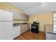 Galley kitchen featuring new appliances, ample counter space, and hardwood floors at 2030 Buford Dam Rd, Buford, GA 30518