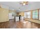 Open kitchen with modern appliances, breakfast bar and access to sunroom with windows at 2030 Buford Dam Rd, Buford, GA 30518