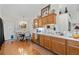 Traditional kitchen features wood cabinets, a long counter, and a chandelier-lit dining area, perfect for Gathering meals at 2030 Buford Dam Rd, Buford, GA 30518
