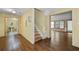 Spacious living room with hardwood floors leading to the bathroom and a naturally lit living area at 2030 Buford Dam Rd, Buford, GA 30518