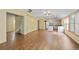 Open concept living room features wood floors, lots of natural light, and a kitchen area at 2030 Buford Dam Rd, Buford, GA 30518