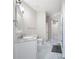 Bathroom with marble floors, white vanity, built in lights, and glass enclosed shower with elegant design at 5300 Peachtree Rd # 3207, Chamblee, GA 30341