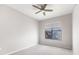 Bright bedroom showcasing a ceiling fan, neutral color palette, carpet floors, and exterior view from the window at 5300 Peachtree Rd # 3207, Chamblee, GA 30341
