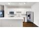Modern kitchen boasts white cabinets, stainless appliances, and center island at 5300 Peachtree Rd # 3207, Chamblee, GA 30341