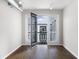 Bright living room featuring hardwood floors, and a balcony with lovely natural light and an open door at 5300 Peachtree Rd # 3207, Chamblee, GA 30341