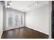 Open living room with hardwood floors and balcony access with bright airy feel at 5300 Peachtree Rd # 3207, Chamblee, GA 30341