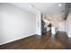 Open floor plan featuring hardwood floors, track lighting, modern kitchen appliances, and stacked washer and dryer at 5300 Peachtree Rd # 3207, Chamblee, GA 30341