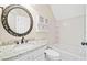 Bright bathroom features vanity with granite counters, decorative mirror and a tiled tub and shower at 5500 Mccoy Nw Rd, Acworth, GA 30101