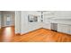Bright kitchen featuring white cabinets, stainless steel appliances, and hardwood floors at 5500 Mccoy Nw Rd, Acworth, GA 30101