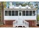 Charming screened porch with white railings and brick base, perfect for relaxing outdoors at 5500 Mccoy Nw Rd, Acworth, GA 30101