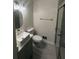 This bathroom features a modern sink, new tile, and a glass enclosed shower at 8236 Tudor Dr, Jonesboro, GA 30238