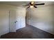 This bedroom features carpet floors, neutral walls, and a large closet at 8236 Tudor Dr, Jonesboro, GA 30238