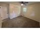 This bedroom features carpet floors, a ceiling fan, and a double door closet at 8236 Tudor Dr, Jonesboro, GA 30238
