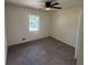 This bedroom features carpet floors, a window and a ceiling fan with a light at 8236 Tudor Dr, Jonesboro, GA 30238