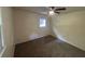 This cozy bedroom features carpet floors, a window, and a ceiling fan with a light at 8236 Tudor Dr, Jonesboro, GA 30238
