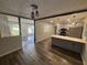 Open-concept dining area with laminate flooring, stylish lighting, and views into the adjacent living room and kitchen at 8236 Tudor Dr, Jonesboro, GA 30238