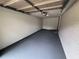 This is a spacious one car garage with painted floors and brick walls at 8236 Tudor Dr, Jonesboro, GA 30238