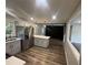 Modern kitchen featuring stainless steel appliances, white quartz countertops, gray cabinets and laminate flooring at 8236 Tudor Dr, Jonesboro, GA 30238