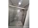 This shower features modern tile, a glass enclosure, and a pebble floor at 8236 Tudor Dr, Jonesboro, GA 30238