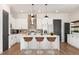 Modern kitchen features white cabinetry, a large island, and stainless steel appliances at 933 Willingham Dr # 9, Hapeville, GA 30354