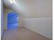 An attic room featuring a carpeted floor and a view into an adjoining room at 1216 Valley Dr, Conyers, GA 30012