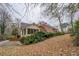 View of the brick home with an inviting screened porch from the landscaped backyard at 1216 Valley Dr, Conyers, GA 30012