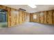 A finished basement with wood paneled walls, carpet flooring, and a door to the backyard at 1216 Valley Dr, Conyers, GA 30012