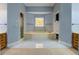 Bathroom featuring double vanities, soaking tub, and tiled floors at 1216 Valley Dr, Conyers, GA 30012