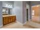 Bathroom with vanity, large mirror, and bedroom access at 1216 Valley Dr, Conyers, GA 30012