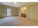 Neutral bedroom featuring ensuite bathroom with double closets, carpeted floors, and a window at 1216 Valley Dr, Conyers, GA 30012