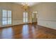 Charming dining room featuring hardwood floors, a chandelier, and large windows with views of the outdoors at 1216 Valley Dr, Conyers, GA 30012