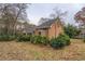 Charming brick home featuring a screened porch, and manicured landscaping at 1216 Valley Dr, Conyers, GA 30012